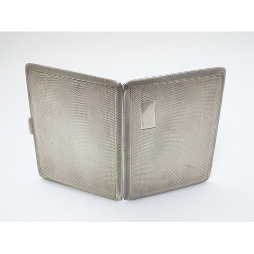 236 - An Art Deco silver cigarette case with engine turned decoration. Hallmarked Birmingham 1940 maker E ... 