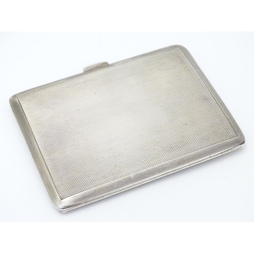 236 - An Art Deco silver cigarette case with engine turned decoration. Hallmarked Birmingham 1940 maker E ... 