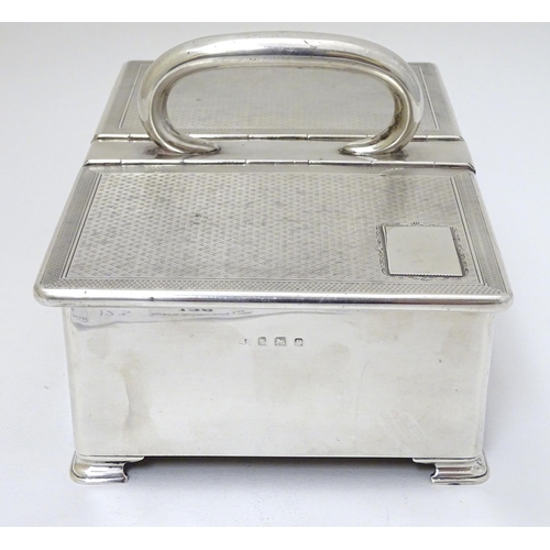 237 - An Art Deco silver table top cigarette box with engine turned decoration, central handle and two hin... 