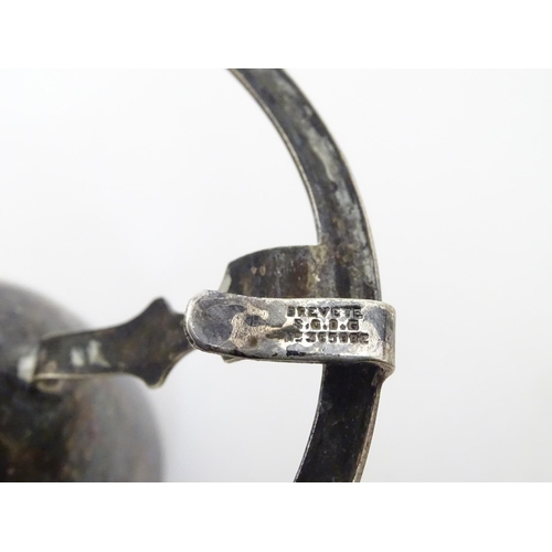 238 - c1901 Silver plated sugar tongs, the grips formed as three running legs ( Isle of Mann emblem) and m... 