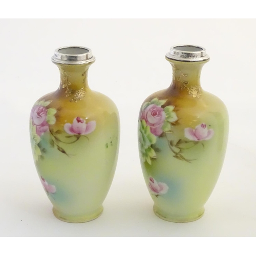 24 - A pair of small Japanese baluster vases with hand painted floral decoration, gilt highlights and sil... 