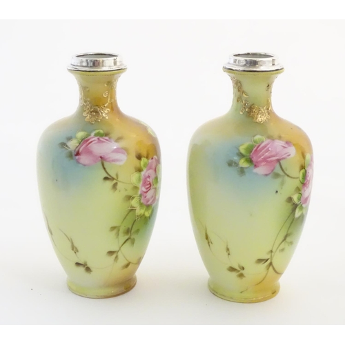 24 - A pair of small Japanese baluster vases with hand painted floral decoration, gilt highlights and sil... 