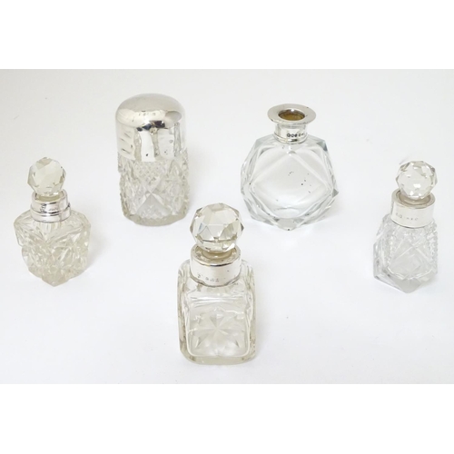 243 - 5 assorted glass scent bottles, some with silver mounts. The tallest 3'' high