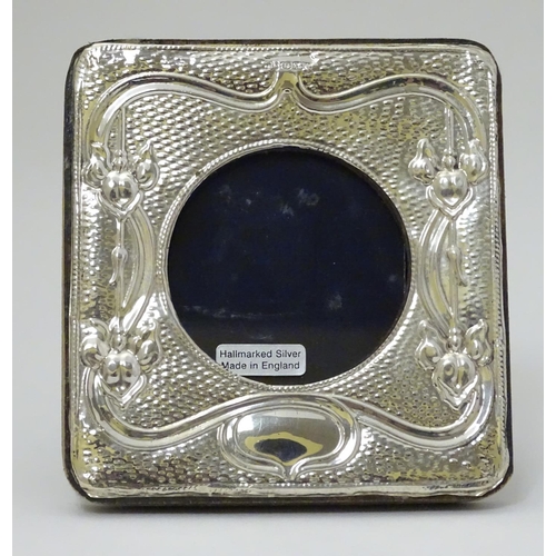 249 - A photograph frame with silver surround hallmarked London 2015 maker HF. The whole 4 1/2'' x 4''