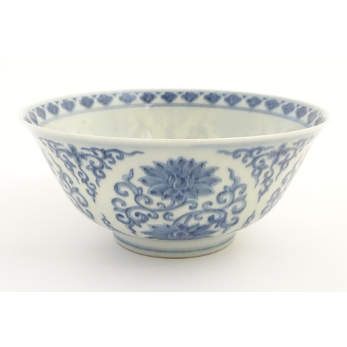 27 - A Chinese blue and white bowl decorated with flowers and scrolling vines. Character marks to base. A... 