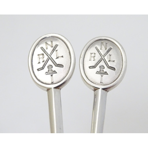 270 - A pair of silver teaspoons marked RNLI to handles and with crossed golf club detail. Hallmarked Shef... 