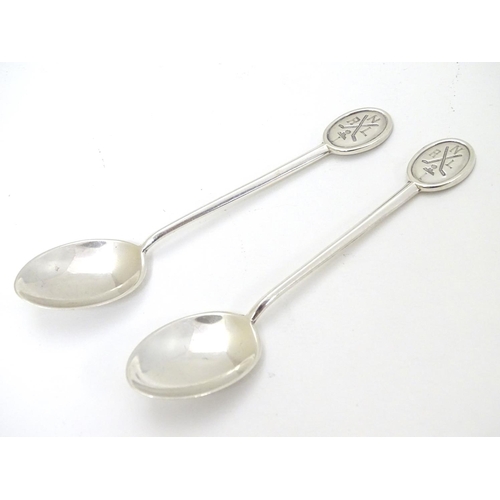 270 - A pair of silver teaspoons marked RNLI to handles and with crossed golf club detail. Hallmarked Shef... 