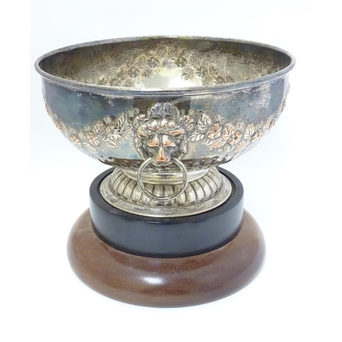 274 - A silver plate pedestal bowl with floral swag decoration and lions mask handle. 10 1/2'' wide