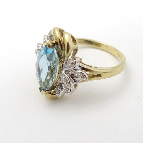 283 - A 9ct gold ring set with central marquise cut topaz flanked by diamonds. The topaz approx 1/2'' long