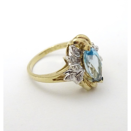 283 - A 9ct gold ring set with central marquise cut topaz flanked by diamonds. The topaz approx 1/2'' long