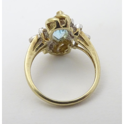 283 - A 9ct gold ring set with central marquise cut topaz flanked by diamonds. The topaz approx 1/2'' long