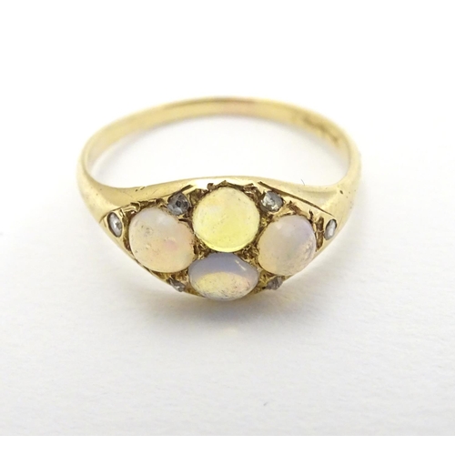 287 - A late 19thC / early 20thC gold ring set with 4 water opal cabochon and 4 diamonds.