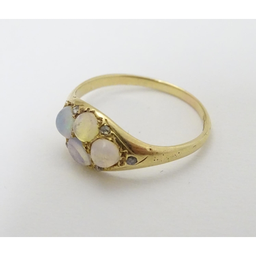 287 - A late 19thC / early 20thC gold ring set with 4 water opal cabochon and 4 diamonds.