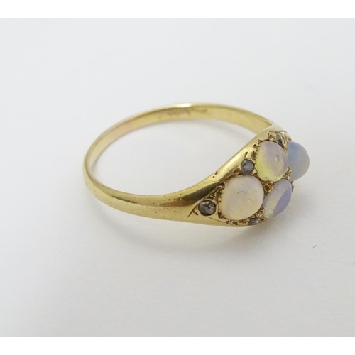 287 - A late 19thC / early 20thC gold ring set with 4 water opal cabochon and 4 diamonds.