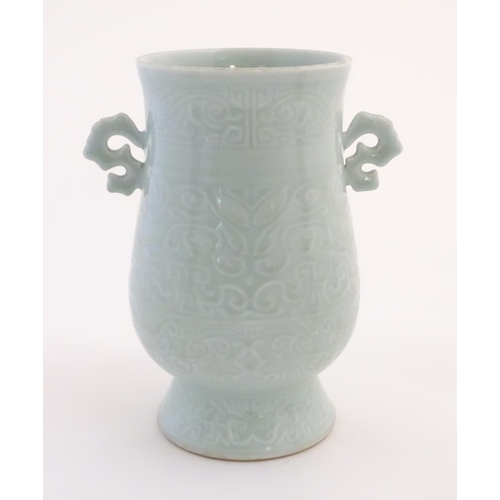 29 - A Chinese celadon 'Jun' shaped vase with scrolling handles, decorated with symbols and patterns. App... 