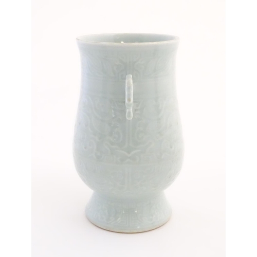 29 - A Chinese celadon 'Jun' shaped vase with scrolling handles, decorated with symbols and patterns. App... 