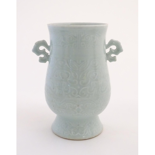 29 - A Chinese celadon 'Jun' shaped vase with scrolling handles, decorated with symbols and patterns. App... 