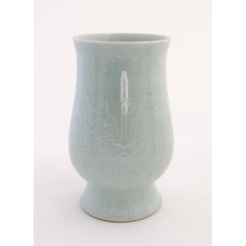 29 - A Chinese celadon 'Jun' shaped vase with scrolling handles, decorated with symbols and patterns. App... 