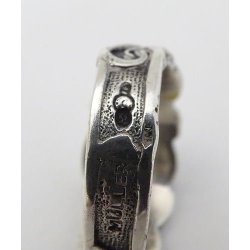 293 - A silver ring with skull and serpent decoration, in the manner of a totenkopf ring. Marked Muller.