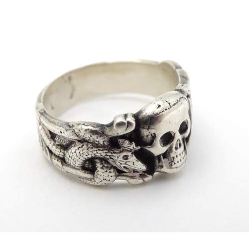 293 - A silver ring with skull and serpent decoration, in the manner of a totenkopf ring. Marked Muller.