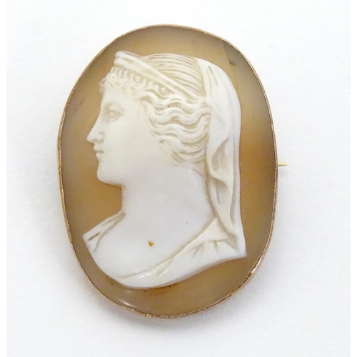 298 - A Victorian shell carved cameo brooch depicting a classical lady in side profile within a 9ct gold m... 