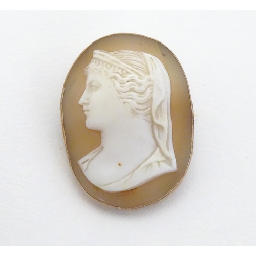 298 - A Victorian shell carved cameo brooch depicting a classical lady in side profile within a 9ct gold m... 