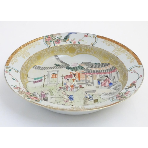 3 - A large Chinese bowl with hand painted scenes of rural life, including a mother and child, figures f... 