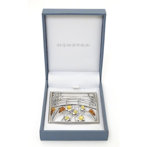 300 - A silver brooch inspired by the work of Claude Monet set with amber detail. 2'' wide. The box marked... 