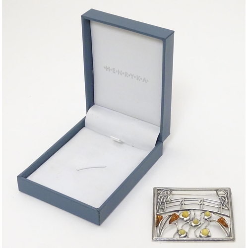 300 - A silver brooch inspired by the work of Claude Monet set with amber detail. 2'' wide. The box marked... 