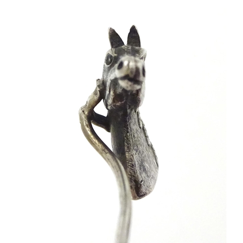 301 - A white metal stick pin surmounted by a horses head. Approx 3'' long overall