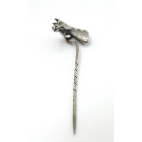 301 - A white metal stick pin surmounted by a horses head. Approx 3'' long overall