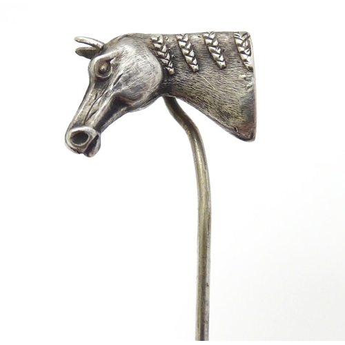 301 - A white metal stick pin surmounted by a horses head. Approx 3'' long overall