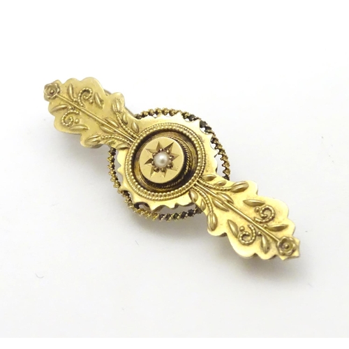 304 - A Victorian 15ct gold brooch set with central pearl. 1 ¾'' wide