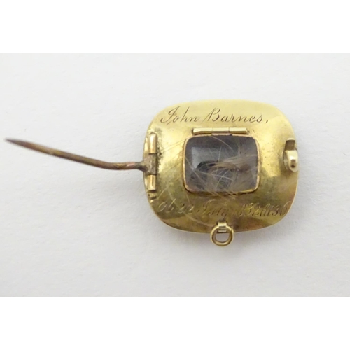 308 - A 19thC mourning brooch set with central lock of hair boarded by pearls and black enamel detail. The... 