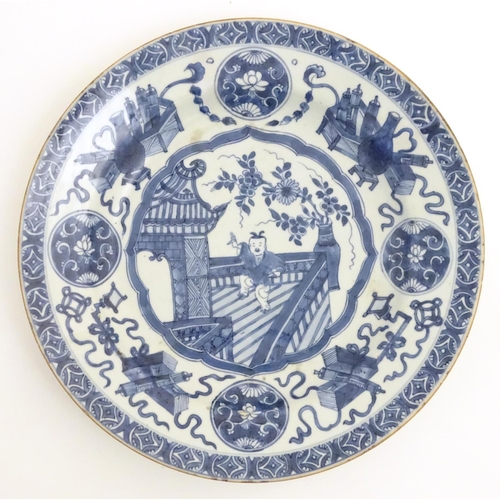 31 - A 19thC Chinese blue and white dish, decorated with auspicious artifacts such as scrolls, vases and ... 