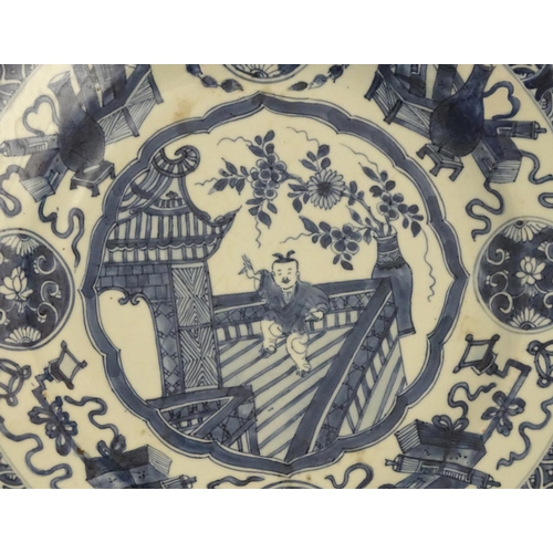 31 - A 19thC Chinese blue and white dish, decorated with auspicious artifacts such as scrolls, vases and ... 