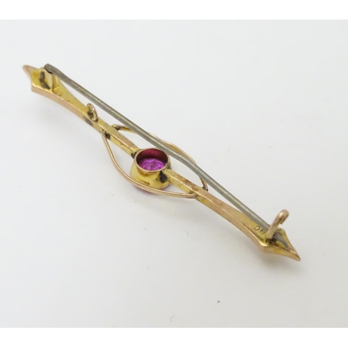 315 - A late 19thC / early 20thC  9ct gold bar brooch set with pink tourmaline. 2 ¼'' wide