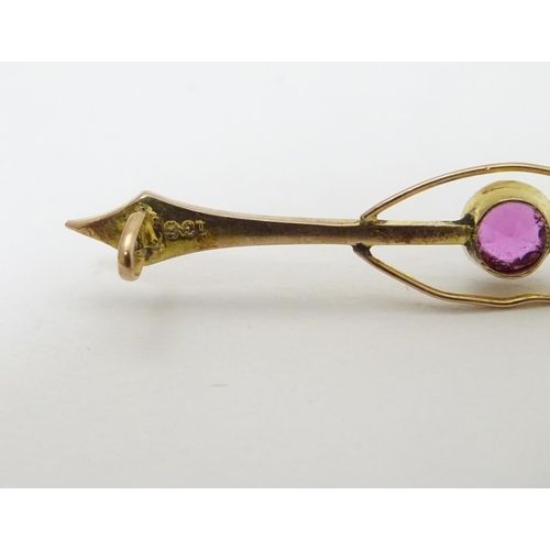 315 - A late 19thC / early 20thC  9ct gold bar brooch set with pink tourmaline. 2 ¼'' wide