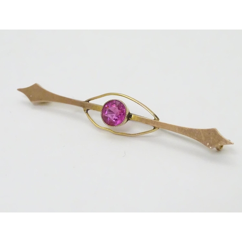 315 - A late 19thC / early 20thC  9ct gold bar brooch set with pink tourmaline. 2 ¼'' wide