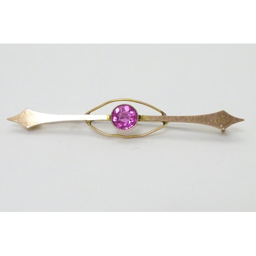 315 - A late 19thC / early 20thC  9ct gold bar brooch set with pink tourmaline. 2 ¼'' wide