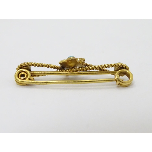 316 - A c1900 gold and gilt metal brooch set with turquoise and seed pearls. 1 1/4'' long