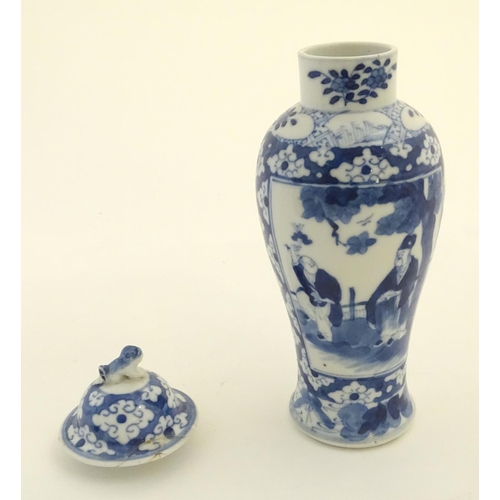 32 - A Chinese blue and white ginger jar decorated with a floral pattern and two panels depicting an elde... 