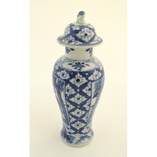 32 - A Chinese blue and white ginger jar decorated with a floral pattern and two panels depicting an elde... 