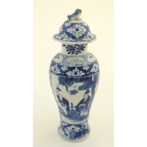 32 - A Chinese blue and white ginger jar decorated with a floral pattern and two panels depicting an elde... 