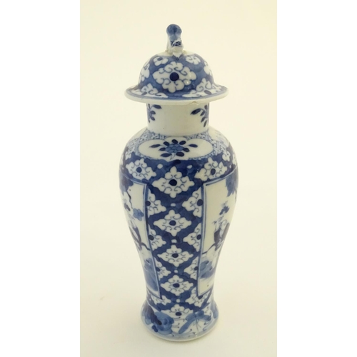 32 - A Chinese blue and white ginger jar decorated with a floral pattern and two panels depicting an elde... 