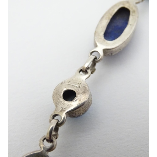 320 - A silver bracelet set with lapiz lazuli and turquoise cabochon.