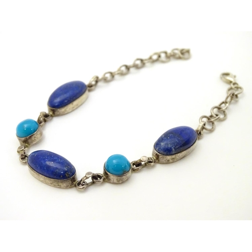 320 - A silver bracelet set with lapiz lazuli and turquoise cabochon.