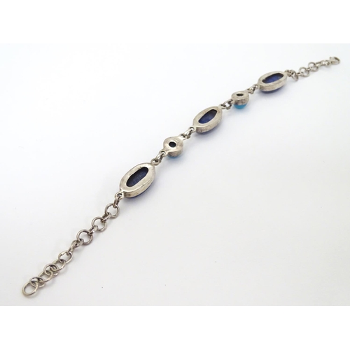 320 - A silver bracelet set with lapiz lazuli and turquoise cabochon.