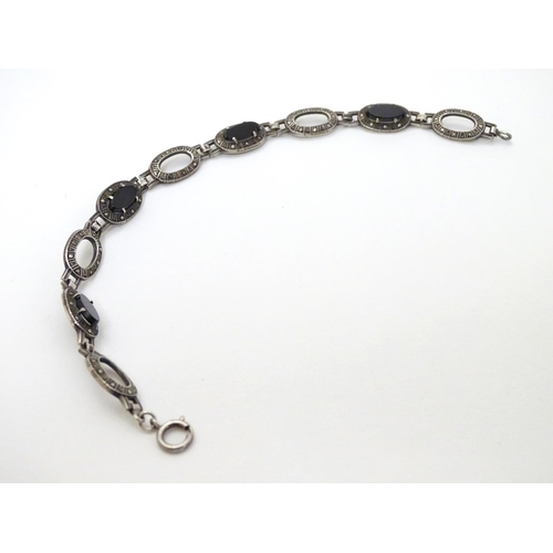 321 - A silver bracelet set with onyx and marcasite