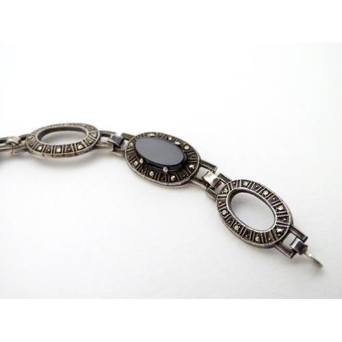 321 - A silver bracelet set with onyx and marcasite